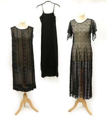 Lot 2055 - A 1920's Black Beaded Sleeveless Dress, the chiffon ground embellished with a geometric design...