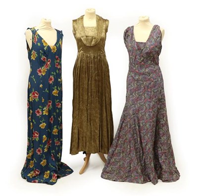 Lot 2064 - Three Circa 1930's Evening Dresses, comprising a gold a black woven full-length dress with cowl...