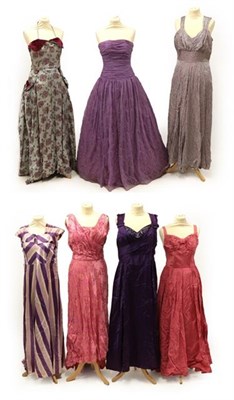 Lot 2085 - Seven Circa 1950's Full Length Evening Dresses, comprising a grey and pink floral brocade...