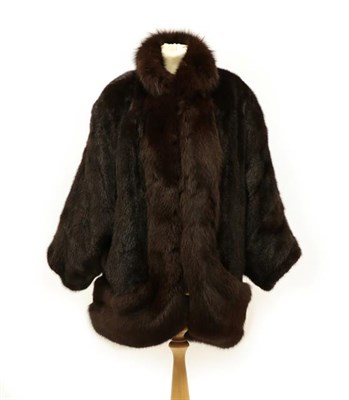 Lot 2114 - A Dark Brown Mink and Fox Fur Coat, with batwing sleeves, the collar, fall and hem trimmed in...