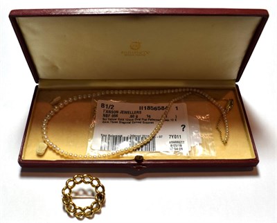 Lot 7 - A cultured pearl necklace in Mikimoto box, length 48cm; and a fixed curb link circular brooch,...