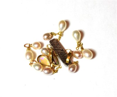 Lot 9 - Eleven cultured pearl charms/pendants, unmarked; together with a 9 carat gold opal pendant,...
