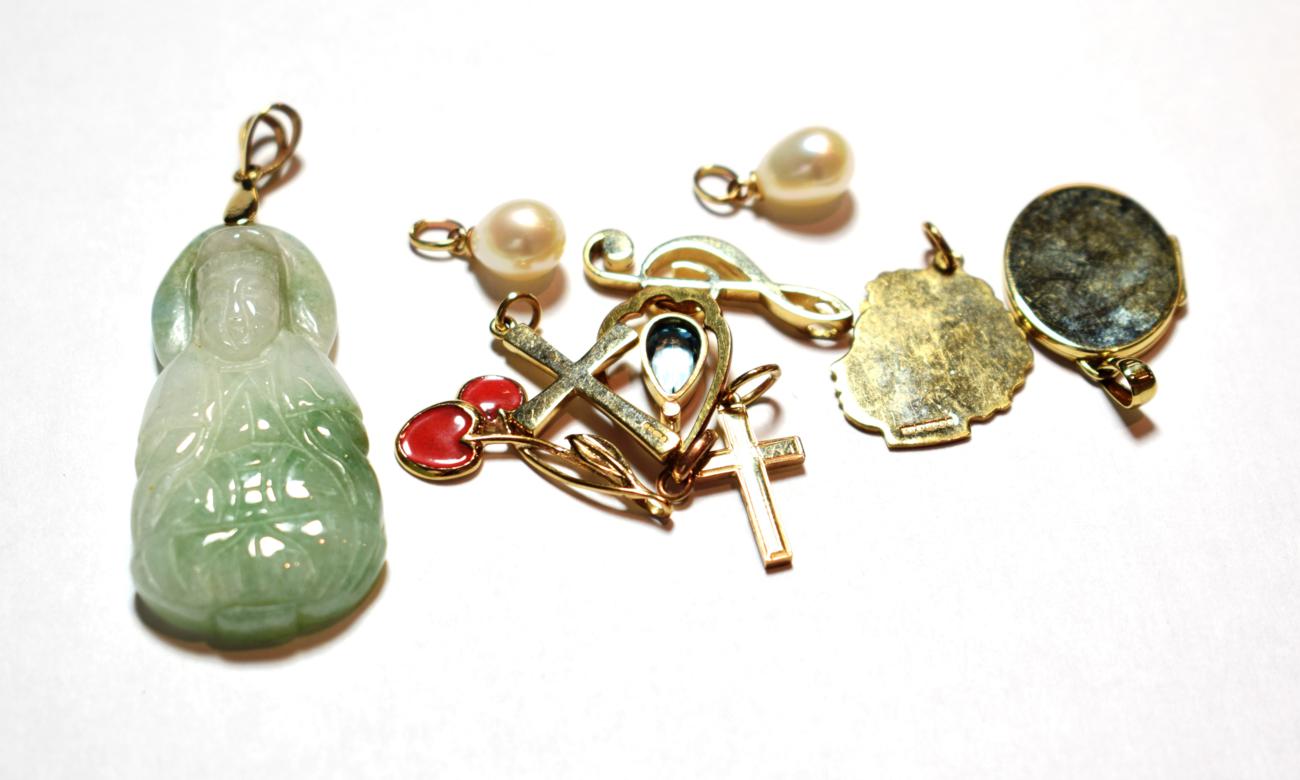 Lot 11 - Six 9 carat gold charms/pendants including two crosses, a locket, a branch of cherries etc; a green