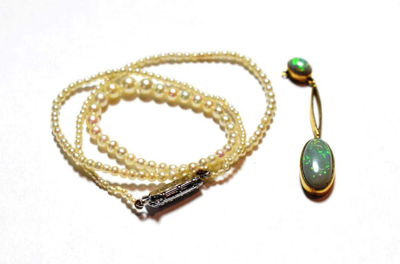 Lot 15 - A cultured pearl necklace with a marcasite set clasp, length 38cm; and an opal drop, stamped...