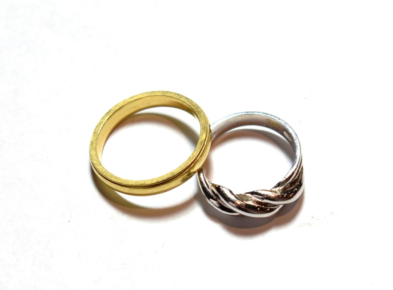 Lot 29 - A 9 carat white gold twist ring, finger size L; and an 18 carat gold band ring, finger size Q