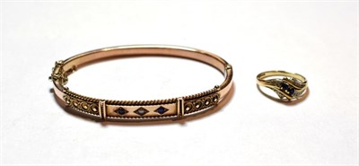 Lot 34 - A 9 carat gold sapphire and split pearl bangle; and a 9 carat gold sapphire and diamond dress ring