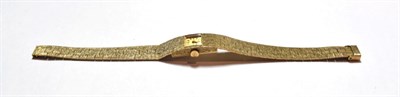 Lot 56 - A lady's 9ct gold wristwatch, bark finished, integral bracelet with clasp stamped .375