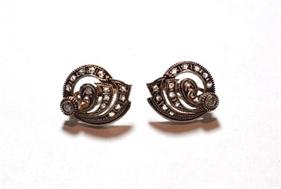 Lot 125 - A pair of diamond cluster earrings, the scroll motif set throughout with rose cut and old cut...