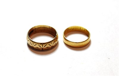 Lot 126 - A 22 carat gold band ring, finger size N; and a 9 carat gold patterned band ring, finger size R