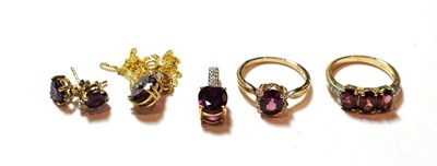 Lot 141 - Two 9 carat gold garnet rings, finger sizes N and N1/2; a pair of garnet earrings, stamped '10K'; a