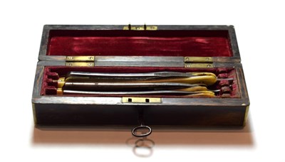 Lot 153 - A 19th century brass mounted coromandel cut throat razer box and associated contents