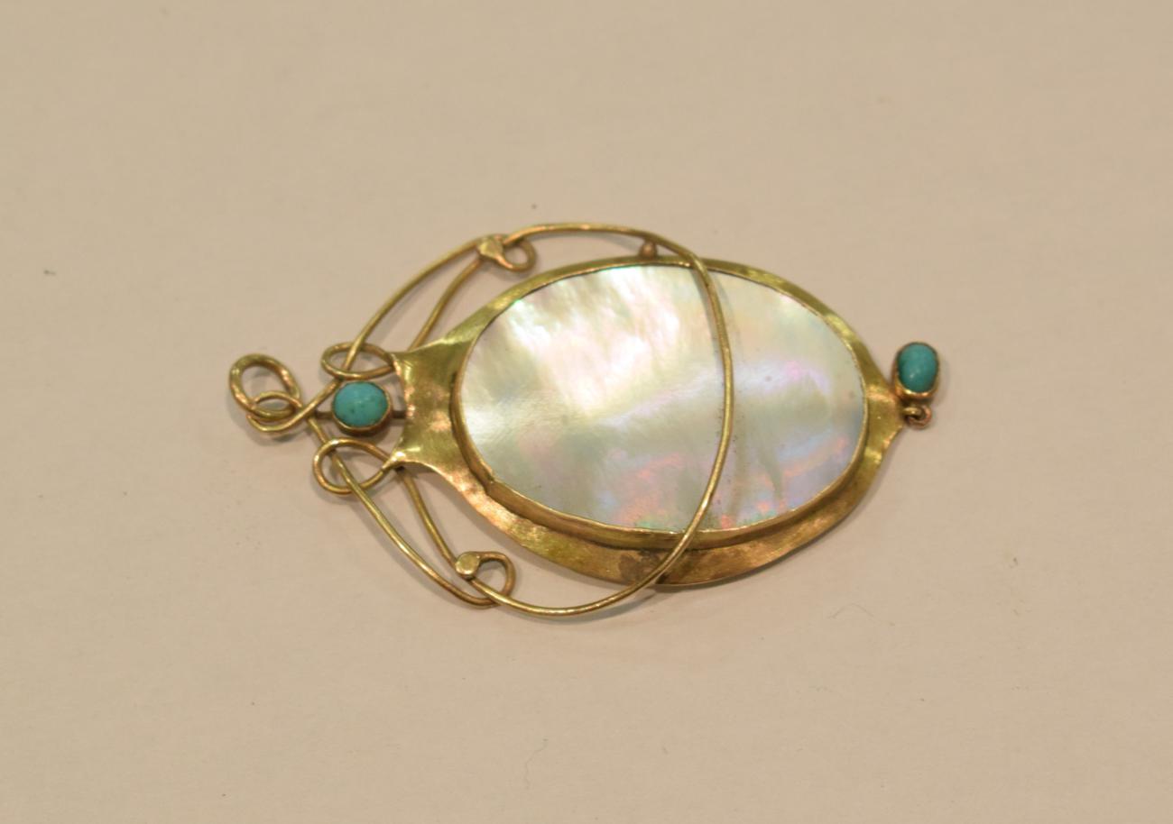 Lot 169 - An Arts & Crafts style mother of pearl and turquoise pendant, stamped '9CT'
