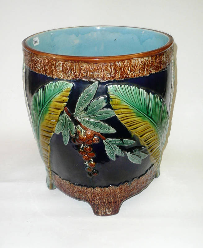 Lot 77 - A Majolica Planter, late 19th century, moulded with a parrot in fruiting branches within bark...