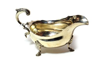 Lot 238 - A George V silver sauceboat, by James Parkes and Co., London, 1937, oval and on three...