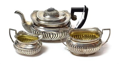 Lot 244 - A three-piece Edward VII silver tea-service, the teapot and cream-jug by William Hutton and...