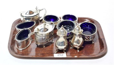 Lot 252 - A collection of silver condiment items, comprising: a plain oval mustard-pot, by Williams...