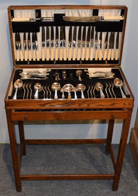 Lot 256 - A silver plated table-service, each with with foliage stamped terminal, in walnut finish...