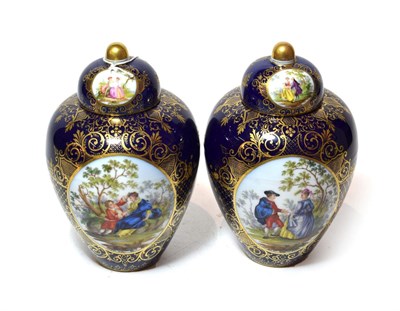 Lot 279 - A pair of Dresden vases and covers, central painted panels of flowers and courting couples to...