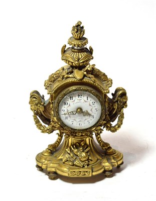 Lot 299 - An ormolu mantel timepiece, circa 1900, urn shaped finial, side rams head masks and swag...