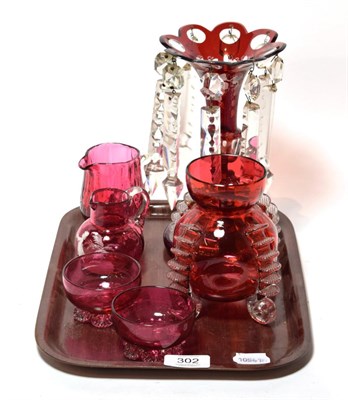 Lot 302 - A 19th century ruby flash glass table lustre; and five pieces of Victorian cranberry glass (6)