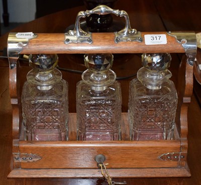 Lot 317 - A silver plated three bottle tantalus