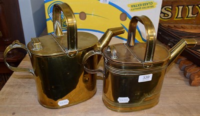 Lot 339 - Two graduated Victorian brass water cans (2)