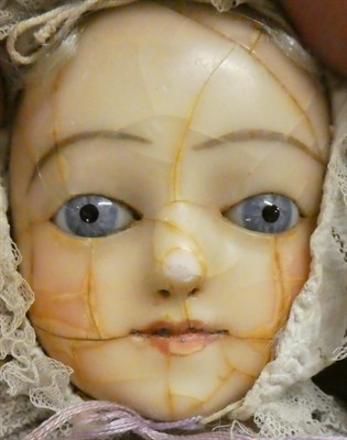 Lot 1038 - Early 19th century wax shoulder head doll (a.f.), with blue eyes, possibly wearing a...