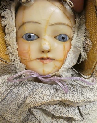 Lot 1038 - Early 19th century wax shoulder head doll (a.f.), with blue eyes, possibly wearing a...