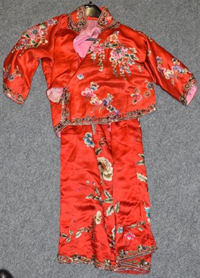 Lot 1046 - A circa 1930s Chinese red silk tunic and skirt, embroidered with prunus with a later sequin trim to