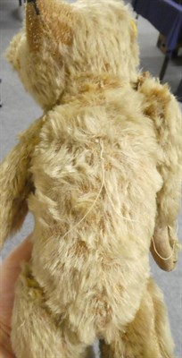 Lot 1060 - Circa 1920s jointed teddy bear, in light brown mohair with boot button eyes, stitched nose and...