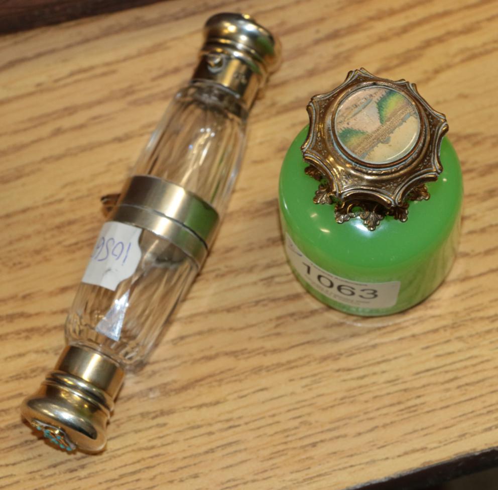 Lot 1063 - Howell & Co London double ended hinged cu,t glass scent bottle, each mount mounted with the...