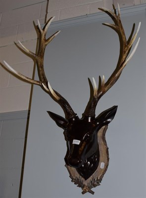 Lot 1141 - A composition black forest style deer head mount on plaque