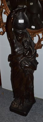 Lot 1142 - A painted plaster figure of a water carrier and child, 106cm high
