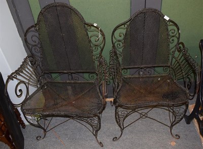 Lot 1150 - Two wire work garden armchairs, with scrolled feet