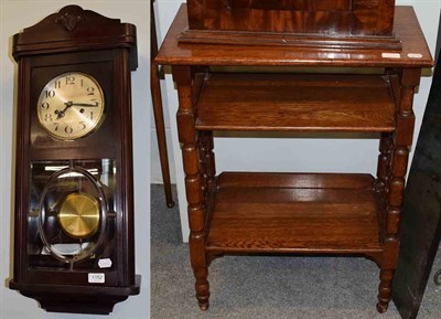 Lot 1152 - An oak two tier occasional table and a Art Deco striking wall clock