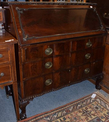 Lot 1171 - An early 20th century Chippendale style carved mahogany bureau, gadrooned apron, on claw and...