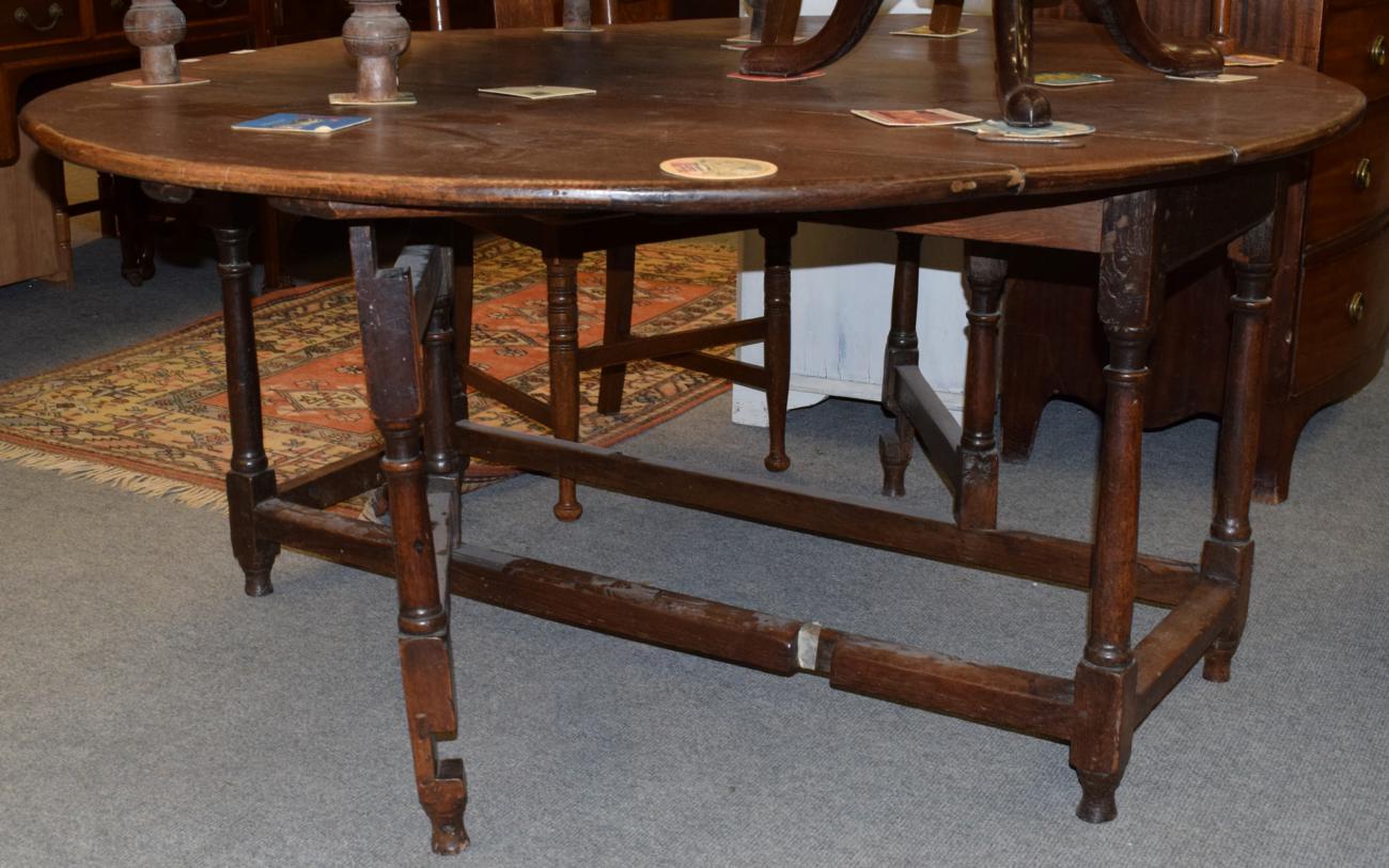 Lot 1174 - An 18th century oak gateleg table