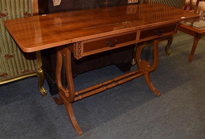 Lot 1202 - A reproduction yew wood sofa table, with lyre form supports, joined by twin stretchers, 77cm by...