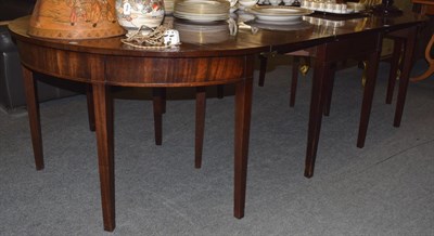 Lot 1203 - A George III mahogany D-end dining table, composed of three sections,with two additional...