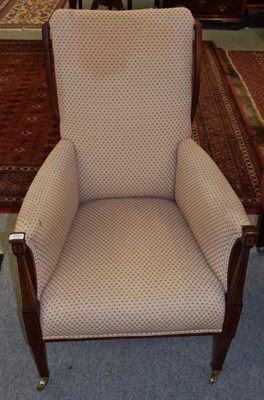 Lot 1209 - An Edwardian mahogany framed armchair upholstered in cream fabric with red dot design