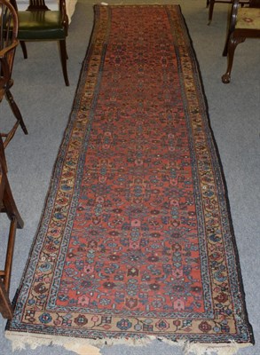 Lot 1222 - North West Persian runner, the terracotta field of Herati design enclosed by narrow borders,...