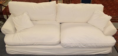 Lot 1228 - A large four seater white linen upholstered feather filled sofa, 260cm long