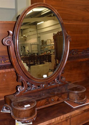 Lot 1243 - A Victorian mahogany dressing mirror, the oval mirror between two scroll carved uprights, on...