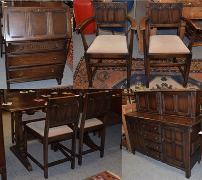 Lot 1252 - A mid 20th century oak dining room suite comprising: sideboard; trestle based table; six chairs...