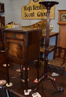 Lot 1253 - A mahogany drop leaf pot cupboard with shelf stretcher; together with a mahogany torchere of...