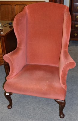 Lot 1270 - A George III wing-back chair, recovered in pink velvet, with outswept arms above an overstuffed...