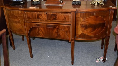 Lot 1271 - A Georgian style inlaid and crossbanded mahogany breakfront bow front sideboard, oak lined, bearing