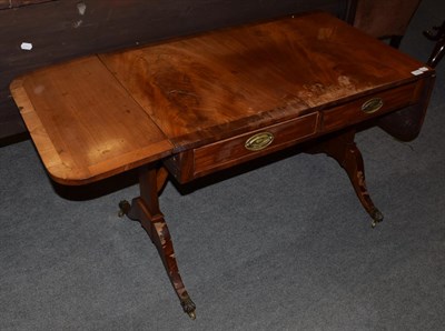 Lot 1273 - A 19th century crossbanded drop leaf sofa table, fitted with two drawers, 75cm by 92cm (closed)...