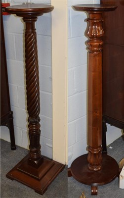 Lot 1274 - A mahogany torchere, the circular top over a boldly turned upright, raised on a square cushion...