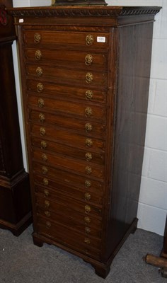 Lot 1281 - An early 20th century oak sixteen drawer straight front chest, the square top above an egg and dart